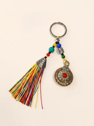 Handmade Tibetan lucky charm tassel keychain with multicolor tassel and prayer wheel pendant.